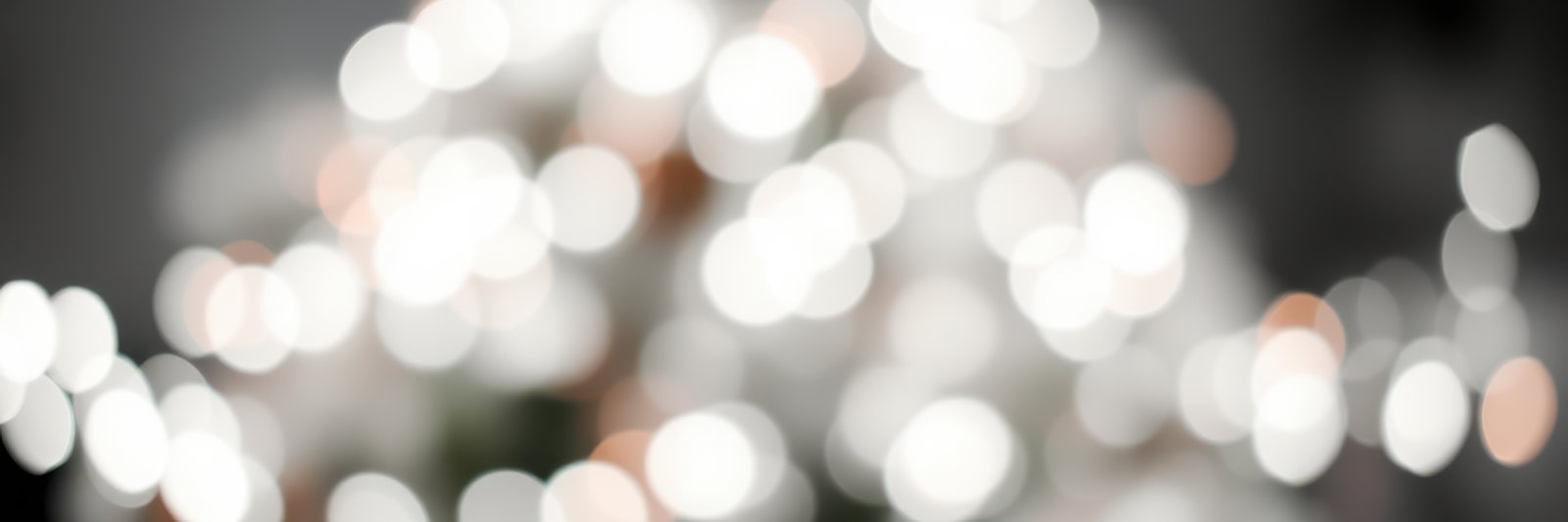 Bokeh background created by sparkling lights in a festive setting during evening hours